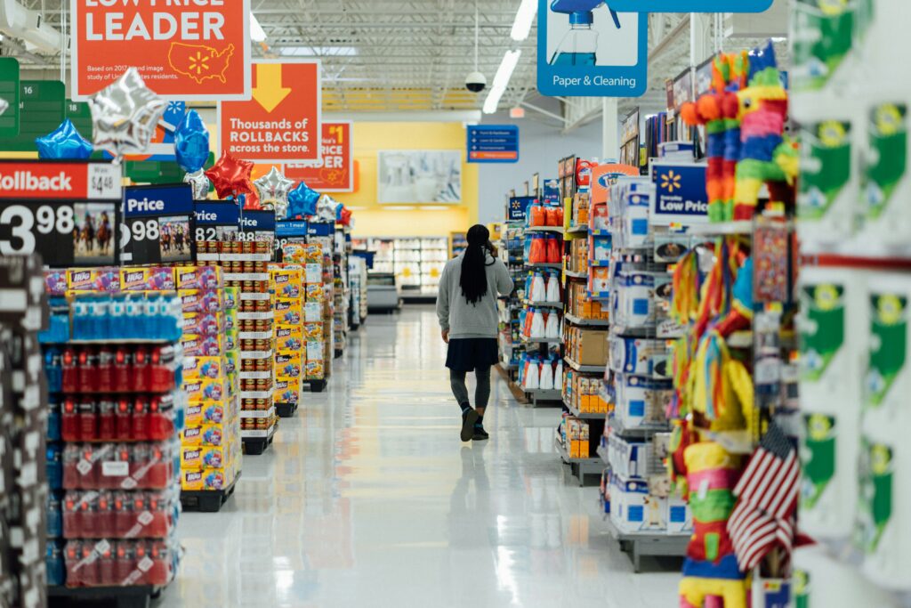 the main aisle at the grocery store with paper and cleaning on the right and grocery on the left