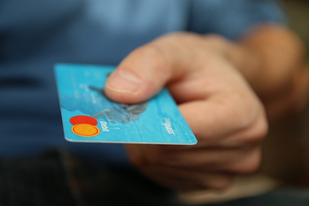 a closeup of a man holding a debit card