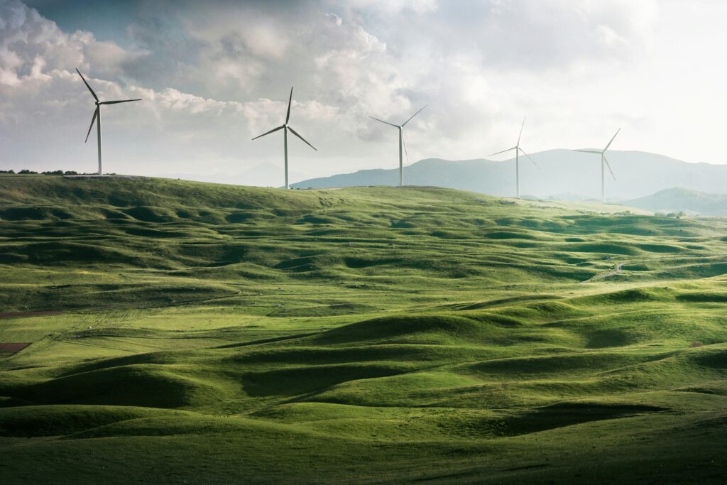 rolling green hills with wind turbines
