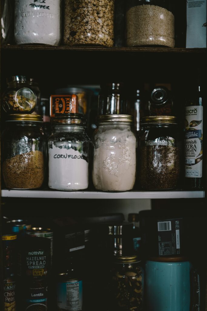 pantry of glass jars with various kitchen ingredients 